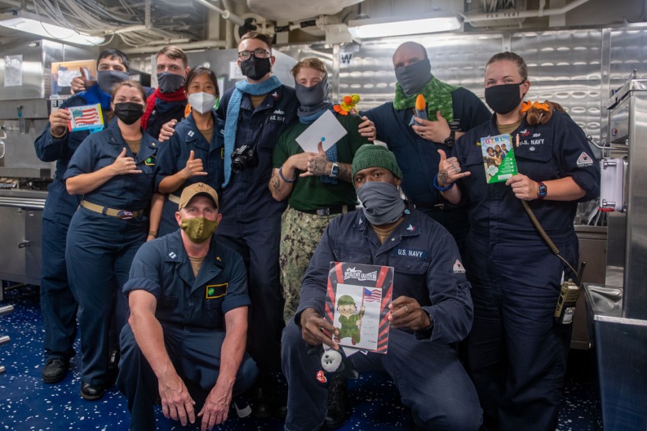U.S. Navy members with care package items